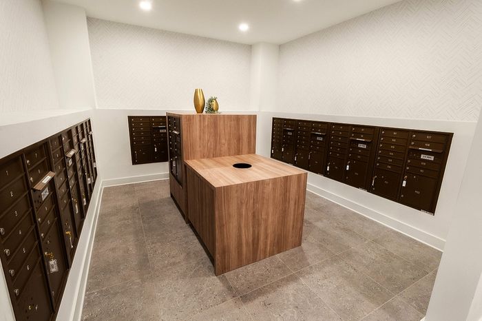 Modern mailroom with sleek brown mailboxes and contemporary decor, offering convenience and style.