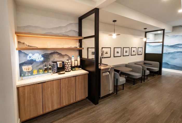 Chic coffee bar area in a modern apartment, featuring stylish seating, contemporary decor, and a welcoming ambiance.
