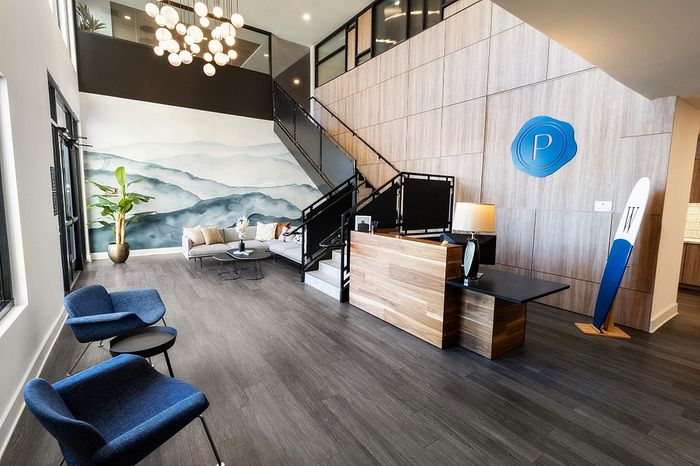 Contemporary lobby with elegant lighting, stylish seating, and modern decor.