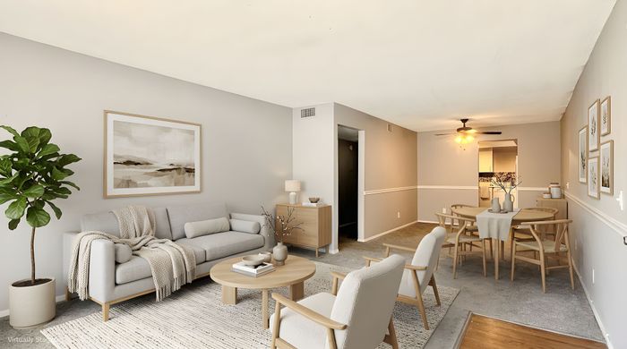 Bright and inviting living room and dining area with modern decor, cozy seating, and elegant lighting, perfect for entertaining and relaxation.