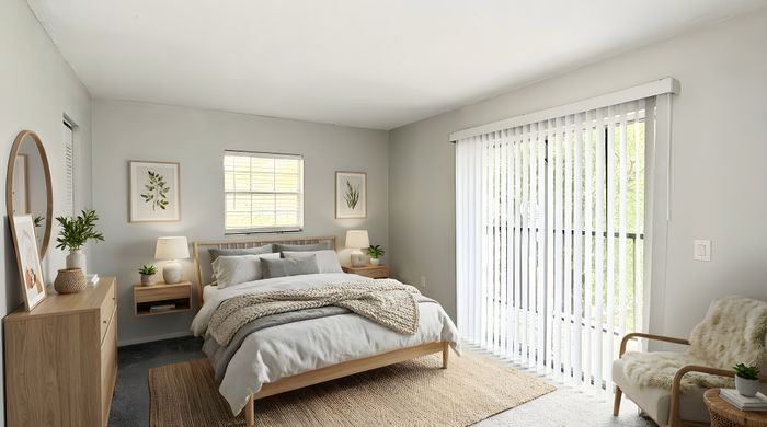 Bright and inviting bedroom featuring a cozy bed, elegant decor, and large windows with vertical blinds for natural light.