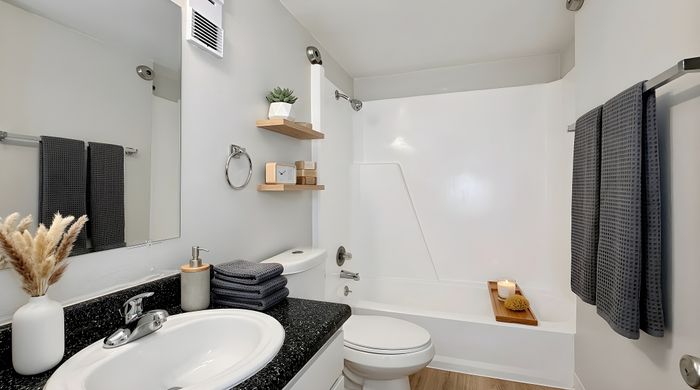 Elegant modern bathroom with sleek fixtures, plush towels, and stylish decor offering a serene retreat.