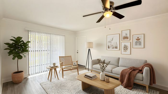 Bright and inviting living room with modern decor, featuring a cozy sofa, elegant wooden furniture, and a lush potted plant by the window.