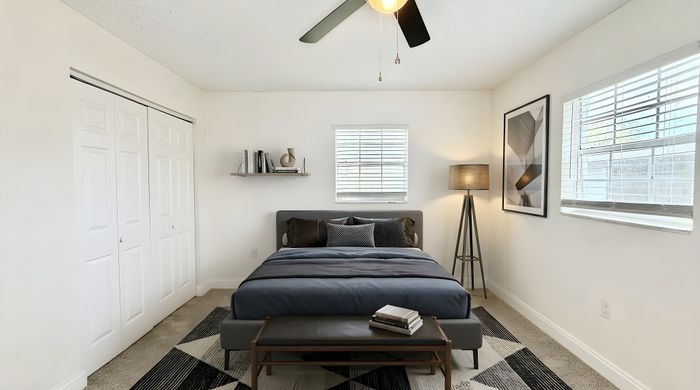 Bright and inviting bedroom with a modern design, featuring a comfortable bed, stylish decor, and natural light filling the space.