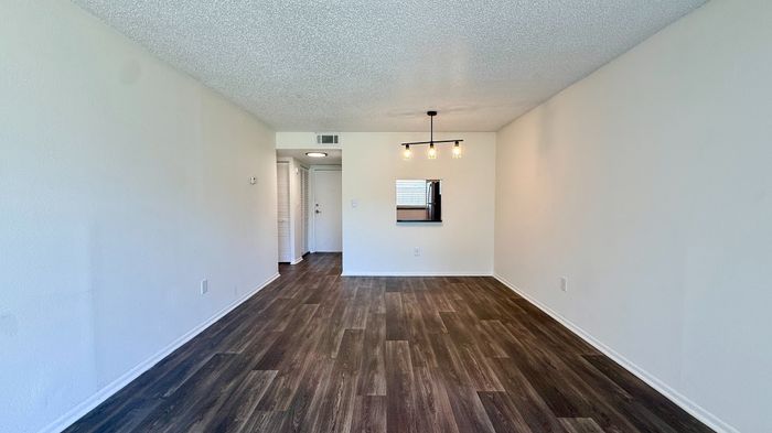 Chic apartment interior with elegant lighting, open layout, and stylish wood flooring.