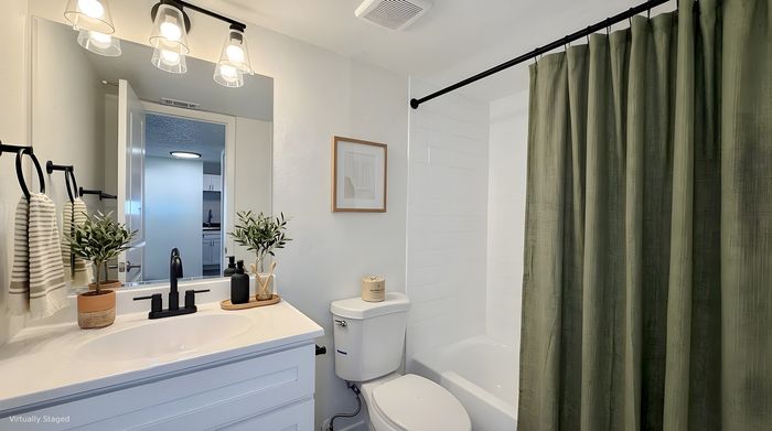 Bright and modern bathroom with elegant vanity, stylish lighting, and luxurious shower complementing the serene ambiance.