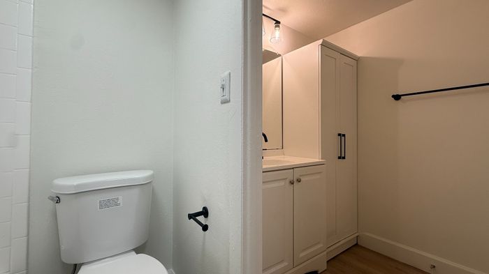 Bright and modern bathroom with elegant vanity, spacious cabinetry, and sleek fixtures.