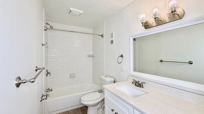 Elegant bathroom with modern fixtures, pristine white subway tiles, and a sleek vanity, enhancing your living experience.