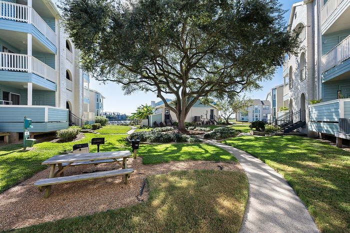 Lakeside at Campeche Courtyard one of many lovely garden walking paths and picnic areas charcoal grills and dog waste bins make outdoor picnics fun and stress free
