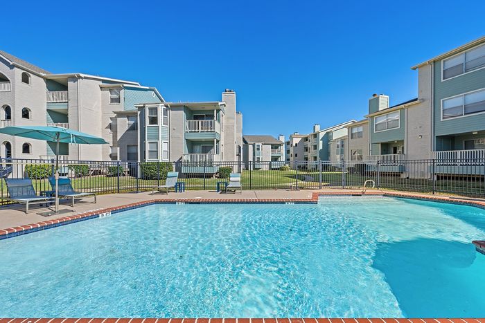 Lakeside at campeche smaller second pool with view of lake outdoor fitness area and dog park locate3d in the center of the property