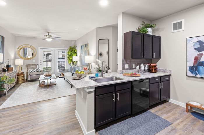 Modern open-concept living space with stylish kitchen, cozy seating area, and elegant decor.