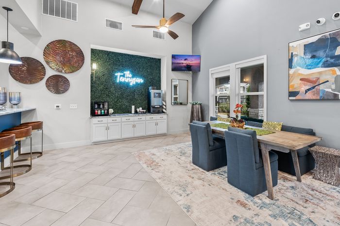 Elegant lounge area featuring stylish decor, cozy seating, and a chic dining table with modern accents.