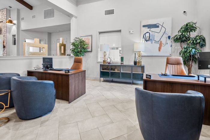 Elegant office space featuring modern d&eacute;cor, sleek desks, and plush seating, perfect for welcoming guests in style.