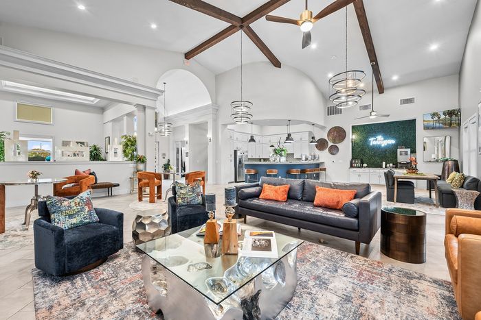 Luxurious modern lounge area featuring plush seating, elegant decor, and a stylish open kitchen perfect for entertaining.
