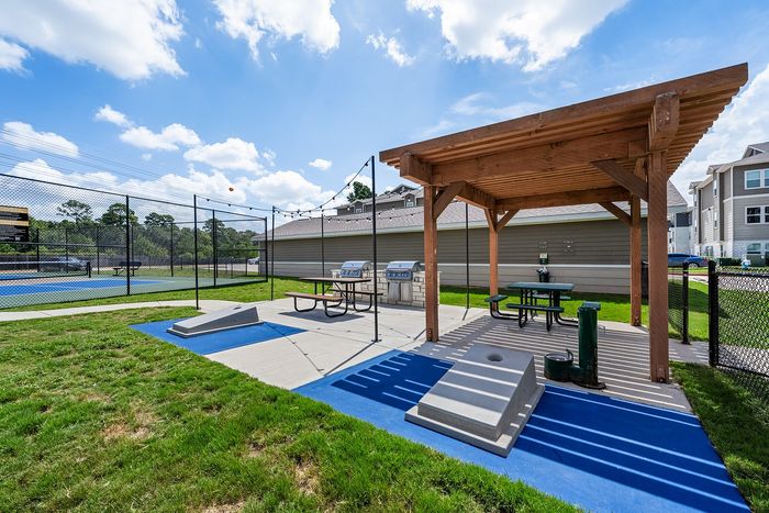 tennyson community game park with cornhole toss games and pickleball courts, gas grill outdoor kitchen, and dogpark