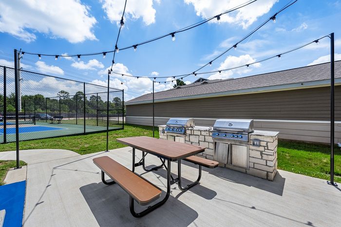 tennyson community game park with cornhole toss games and pickleball courts, gas grill outdoor kitchen, and dogpark