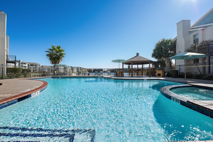 Lakeside at Campeche Outdoor Fitness Area in the shade of aa building is aa prime spot to hit your fitness goals while enjoying the fresh air and the amazing lake side views