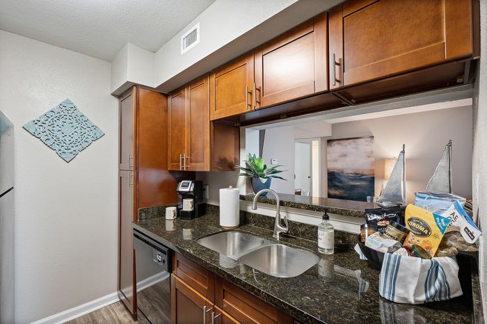Lakeside at Campeche 2 bed 2 bath model front entrance looking into living room dinigroom and guest bathroom