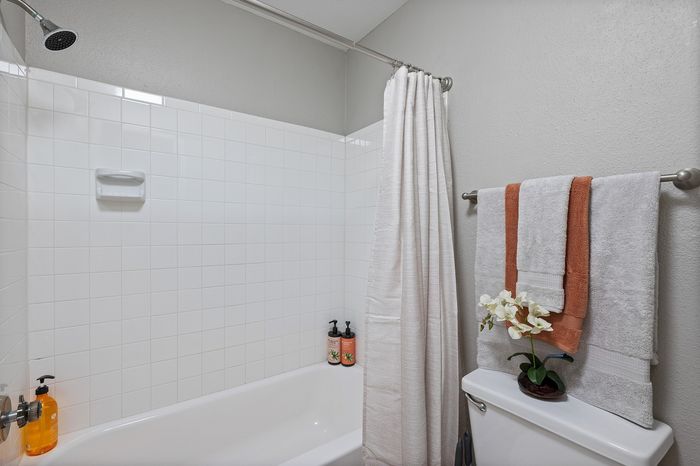 Lakeside at Campeche 2 bed 2 bath model front entrance looking into living room dinigroom and guest bathroom