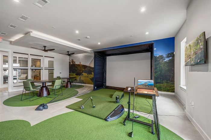 Chic recreational room with modern pool table, stylish brick walls, comfortable seating, and elegant lighting.