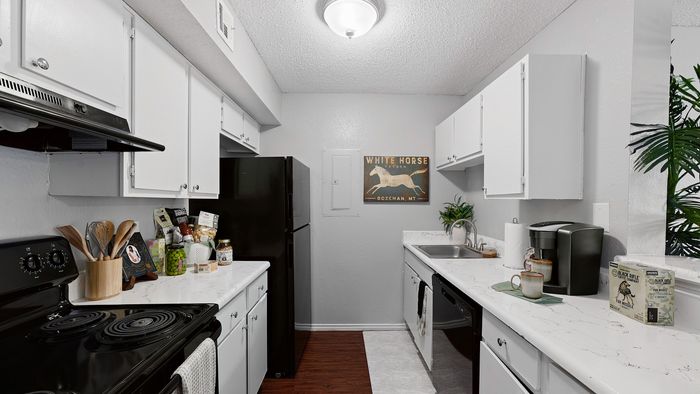 Contemporary kitchen with sleek white cabinets, modern appliances, and stylish decor, perfect for culinary inspiration.