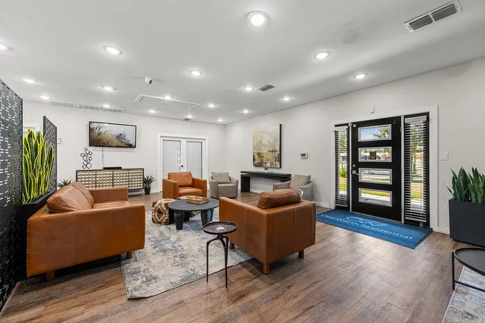 Sophisticated modern interior featuring plush leather seating, elegant d&eacute;cor, and abundant natural light ideal for relaxation and entertainment.