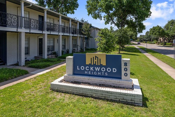 Charming Lockwood Heights apartment complex with elegant two-story design and lush greenery, offering a serene living environment.