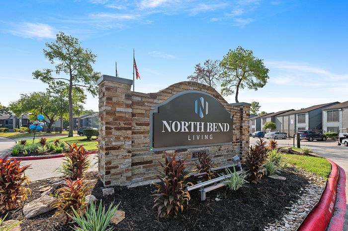 Inviting North Bend Living sign surrounded by lush landscaping, promoting a vibrant and welcoming community atmosphere.