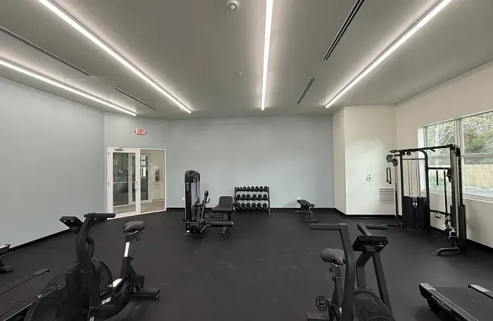 Bright and spacious fitness facility featuring various exercise equipment and clean flooring.
