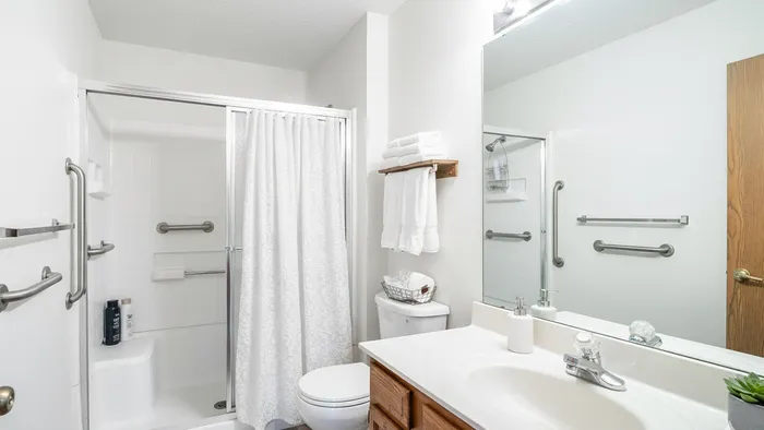 Bright and airy bathroom with modern fixtures, ample storage, and elegant white decor.