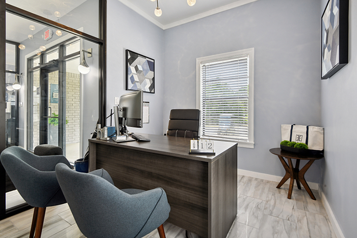 Modern office space with sleek furniture, bright lighting, and contemporary decor, perfect for a professional yet welcoming atmosphere.