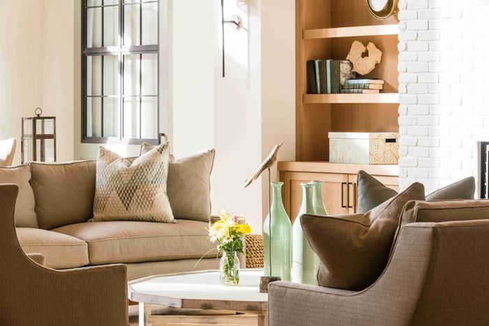 Resident lounge with sofas, armchairs, coffee tables and a fireplace.