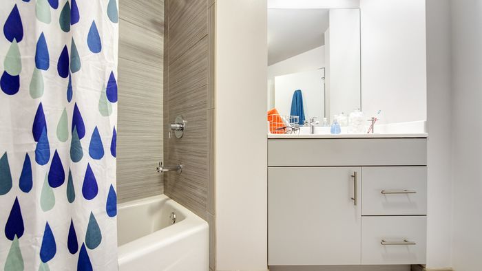 Spacious, large, luxury, modern bathroom with tile flooring, bath tub