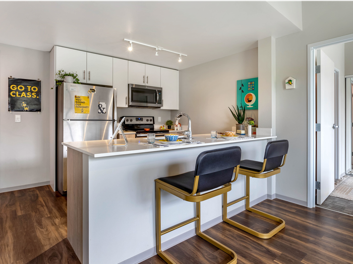 bar stools, rug, wood flooring, kitchen, open-concept, island, living room