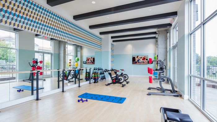 Bike machines, yoga mats, mirrors, TV, On-demand fitness, stretch, spinning