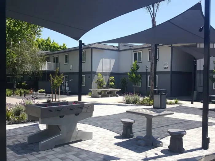 Resident Enjoying Community Grounds | Sacramento State Apartments | University Village