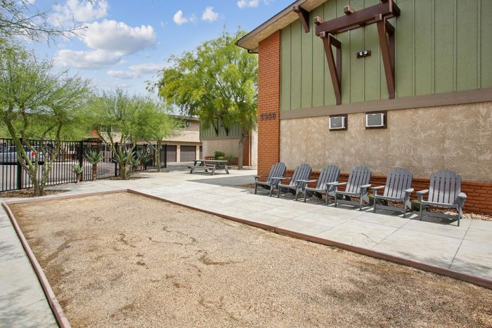 Inviting outdoor space with modern seating, lush greenery, and contemporary architecture, perfect for relaxation.