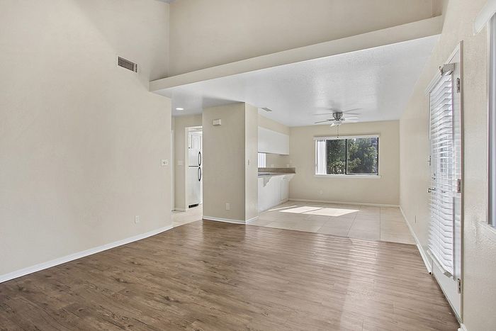 Bright and airy open-concept living space with elegant hardwood floors, modern kitchen, and abundant natural light.