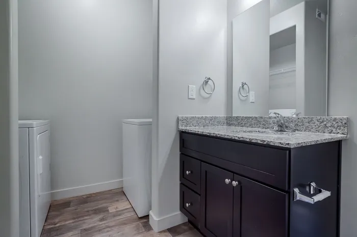 Guest bathroom showing entry to laundry area
