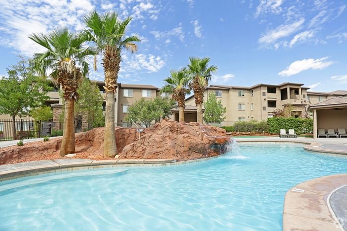large pool behind clubhouse with waterfall feature