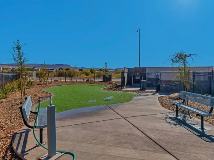Dog park with 2 benches and grass area