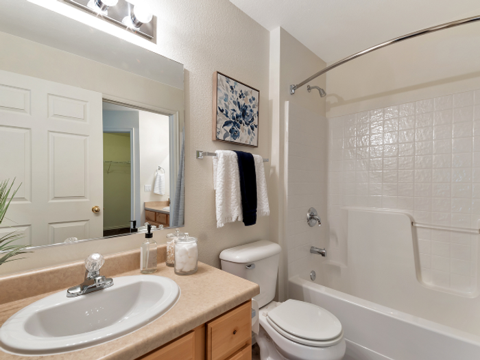 bathroom in model with shower curtain open