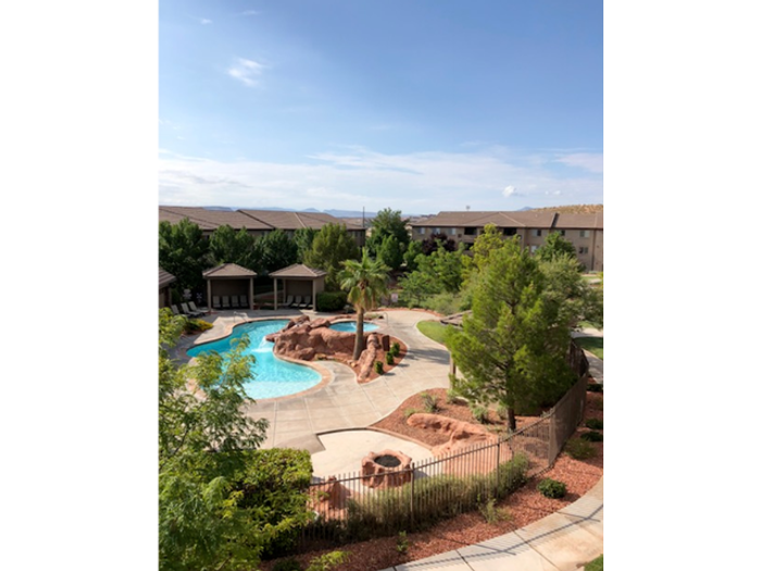 Outdoor Fire Pit and view of clubhouse pool and hot tub