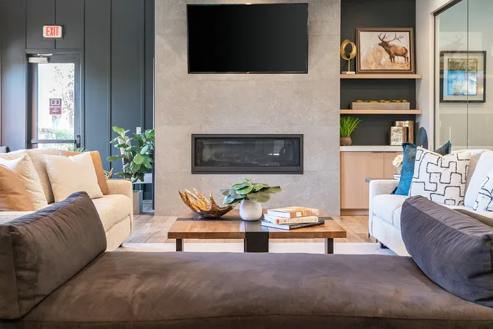 Modern living room with cozy sofas, stylish fireplace, and elegant decor, perfect for relaxed gatherings.