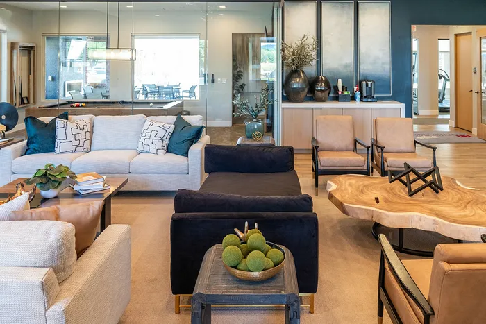 Inviting living room with modern furniture, chic decor, and a stunning natural wood coffee table, perfect for luxurious relaxation.
