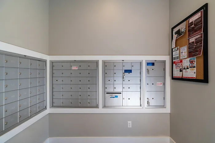 Secure and convenient mailroom with individual mailboxes and community notice board.