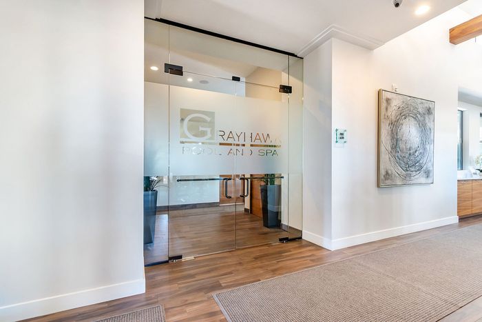 Inviting entrance to Grayhawk Pool and Spa, showcasing elegant glass doors and sophisticated interior design.