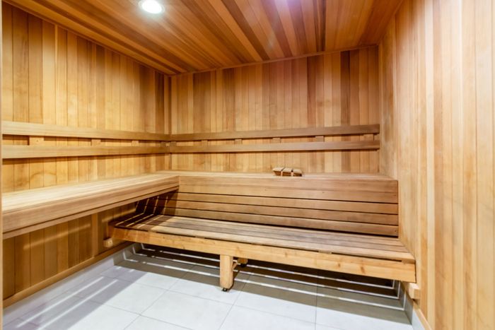 Inviting sauna room with sleek wooden interior and ambient lighting, perfect for relaxation and rejuvenation.