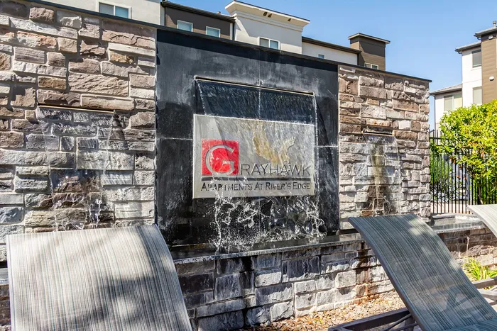 Chic outdoor water feature at Grayhawk Apartments with cascading waterfalls and elegant stonework, creating a serene ambiance.