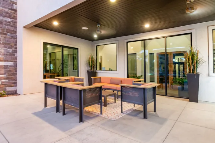Modern outdoor patio with elegant seating area and stylish lighting, ideal for relaxed gatherings.